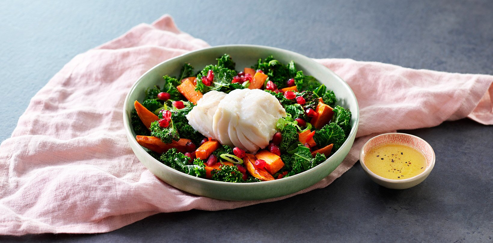 Poached skrei on a bed of sweet potato and kale