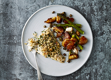 Herb crusted Norwegian haddock tray bake with crispy potatoes and asparagus