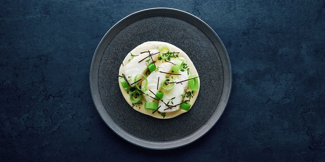 Baked skrei with potatoes, leek and truffle