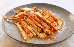 Oven-baked snow crab with herb butter